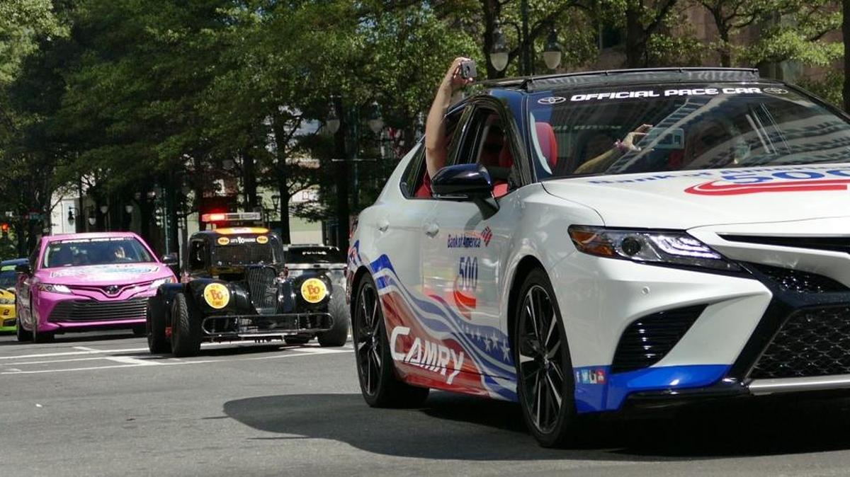 Race cars and racing-themed vehicles participate in the Charlotte Motor Speedway Laps around Uptown, Tuesday Oct. 3, 2018.