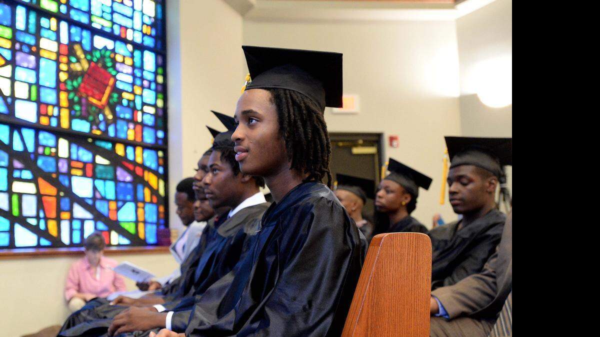 
 Graduate DeCarlo Mackey, center, West Charlotte High, listens to the guest speaker during the graduation celebration hosted by Mecklenburg County Sheriff's Office (MCSO), Communities In Schools (CIS), and Charlotte- Mecklenburg Schools (CMS), June 03,2015 at First Baptist Church West.
