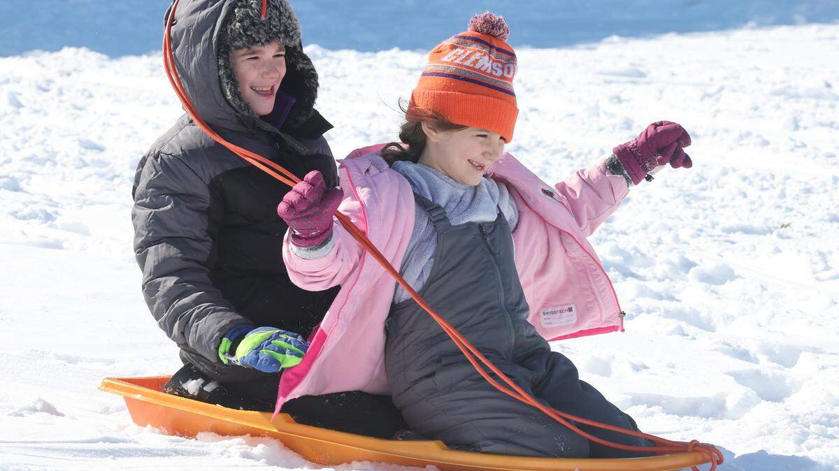 9-year-old William Brown, left, and 7-year-old Caroline Brown sled at the Winthrop Coliseum Sunday in Rock Hill.