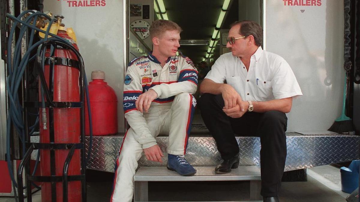 Dale Earnhardt Jr. and his dad sit on the back of the latter’s transporter at Carquest 300 Grand National qualifications at Charlotte Motor Speedway in 1998.