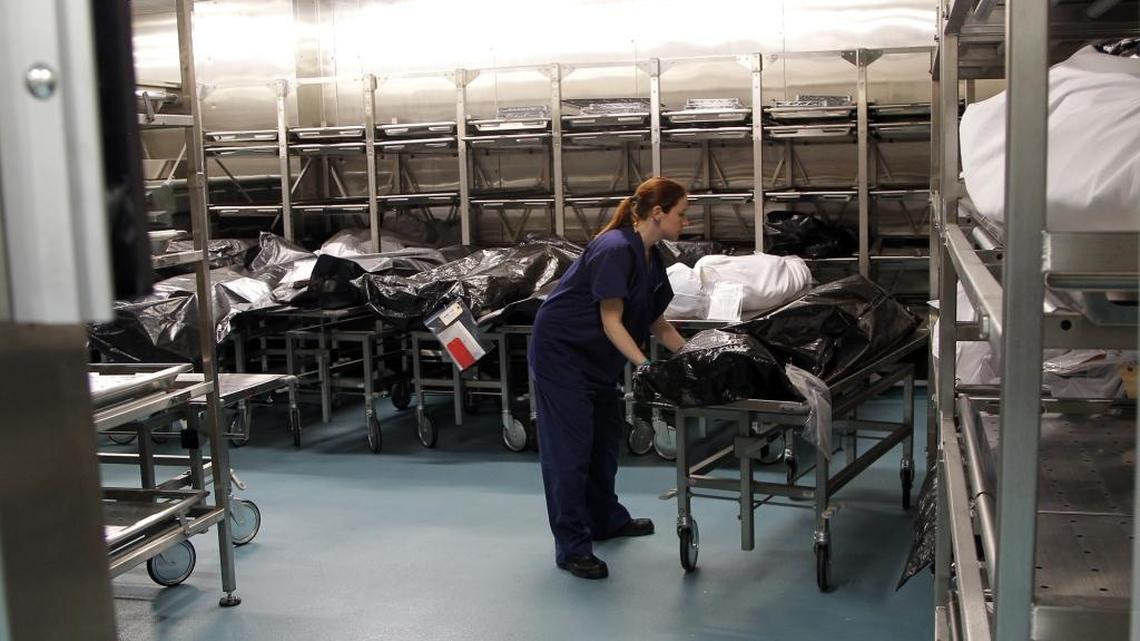 
Sandra Jones, an autopsy technician, wheels a body out of the chilled body morgue after an autopsy at the state medical examiner's office. The office investigates about 11,000 cases each year at several state facilities. Some families have complained about the length of time it takes to get a death ruling from the state.
