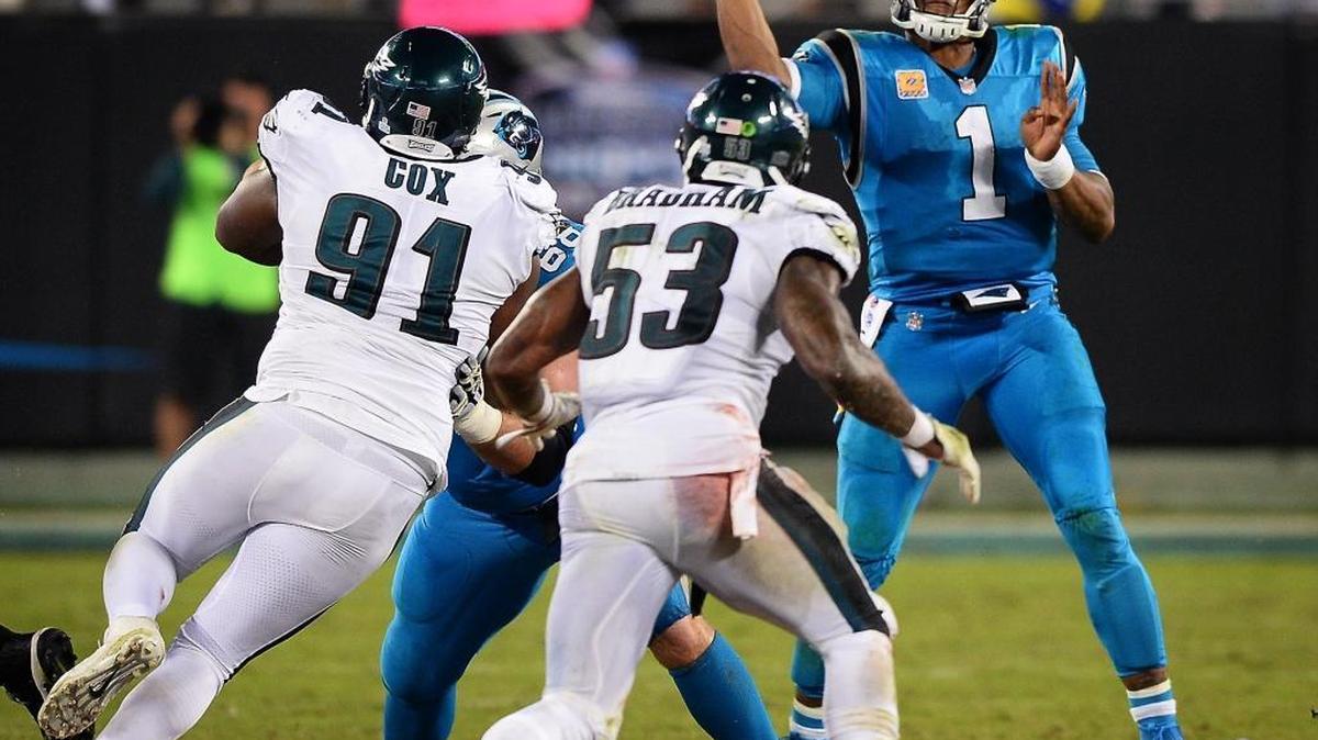 Carolina Panthers quarterback Cam Newton passes to a receiver as Philadelphia Eagles defensive tackle Fletcher Cox and linebacker Nigel Bradham rush during fourth quarter action on Oct. 12 at Bank of America Stadium. The Panthers lost to the Eagles 28-23.