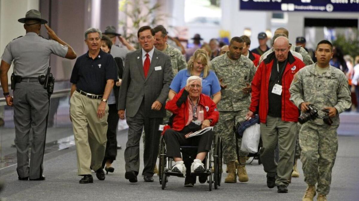 Former state Sen. John Drummond, a World War II pilot, arrives from an Honor flight Wednesday. Drummond received a surprise welcome from Lt. Gov. Glenn McConnell and Senator Nikki Setzler.