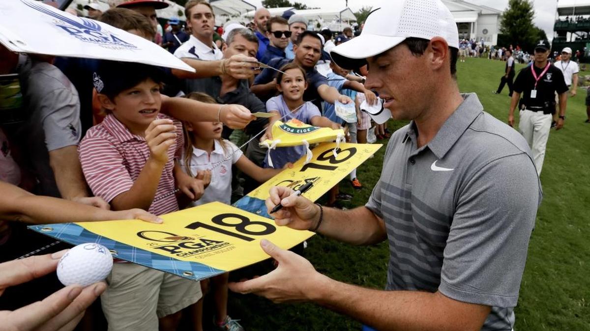 Rory McIlroy sign autographs after a practice round at the PGA Championship at Quail Hollow Club on Tuesday. Medical teams treated more than 100 patients on both Monday and Tuesday.
