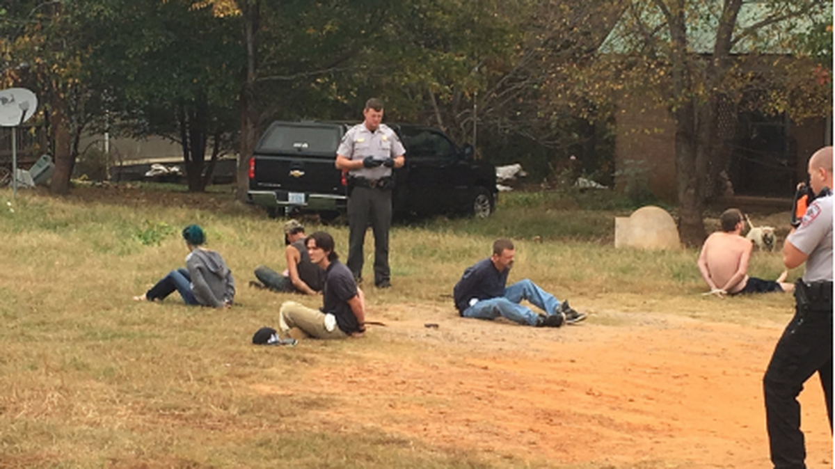Suspects in hand cuffs at scene of drug bust in Iredell County