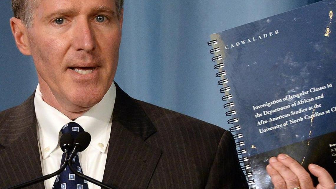 Kenneth Wainstein, a partner with Cadwalader, Wickersham & Taft LLP holds up the report on UNC-Chapel Hill's academic problems in association with the athletics department during a press conference on October 22, 2014.