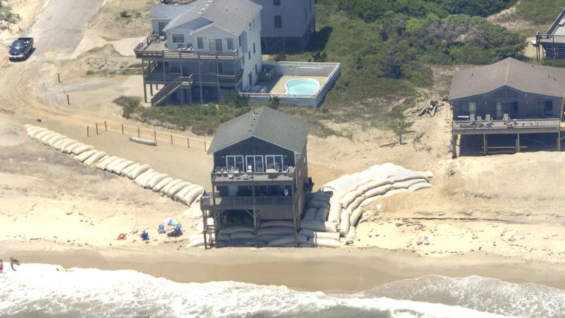 Temporary sandbags protect a beach house in Nags Head in this 2011 photo. A study by the Union of Concerned Scientists, an advocacy group, predicts that up to 63 N.C. coastal communities could be “chronically inundated” by 2100.