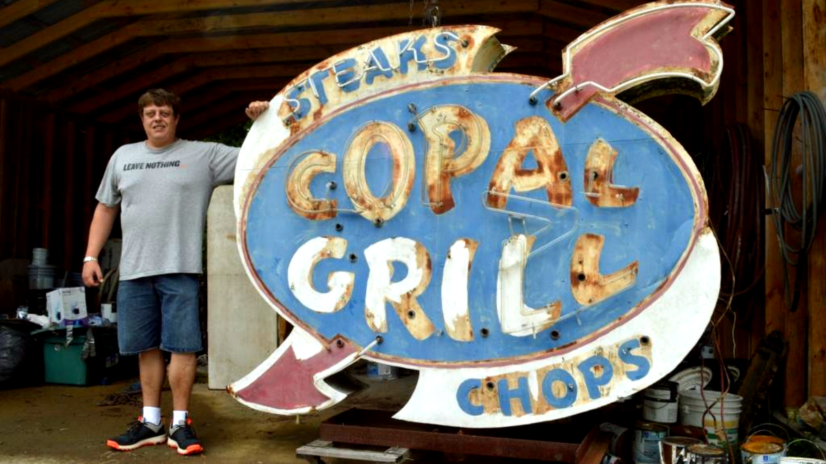 
Jason Spears with Copal Grill Neon Sign he purchased off Craigslist this month. 
