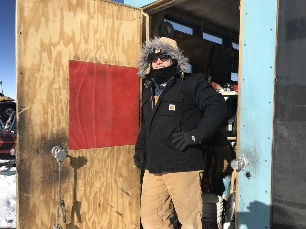 Professional engineer Justin Marsh, a UNCC graduate, in the fuel pump shack of the South Pole Traverse Fuel Offload, where fuel is pumped into tanks under the ice sheet.