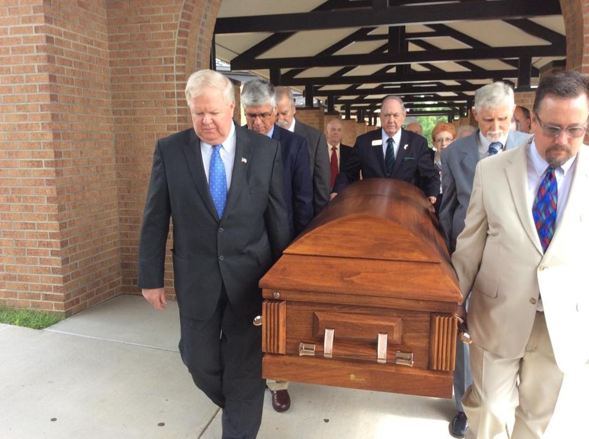 A procession takes Francis Mariea’s casket to a hearse after his funeral at St. Therese Catholic Church in Mooresville on Monday.