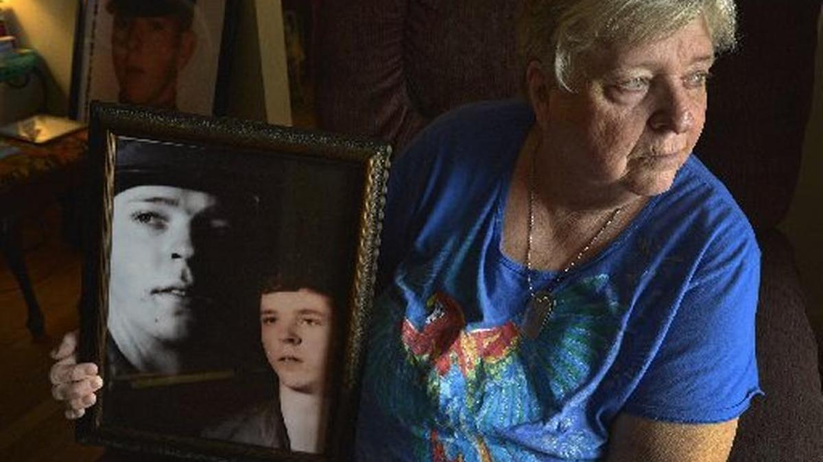 
Bunyan Price Jr.’s sister Wanda Hanley of Charlotte holds photos of her brother.
