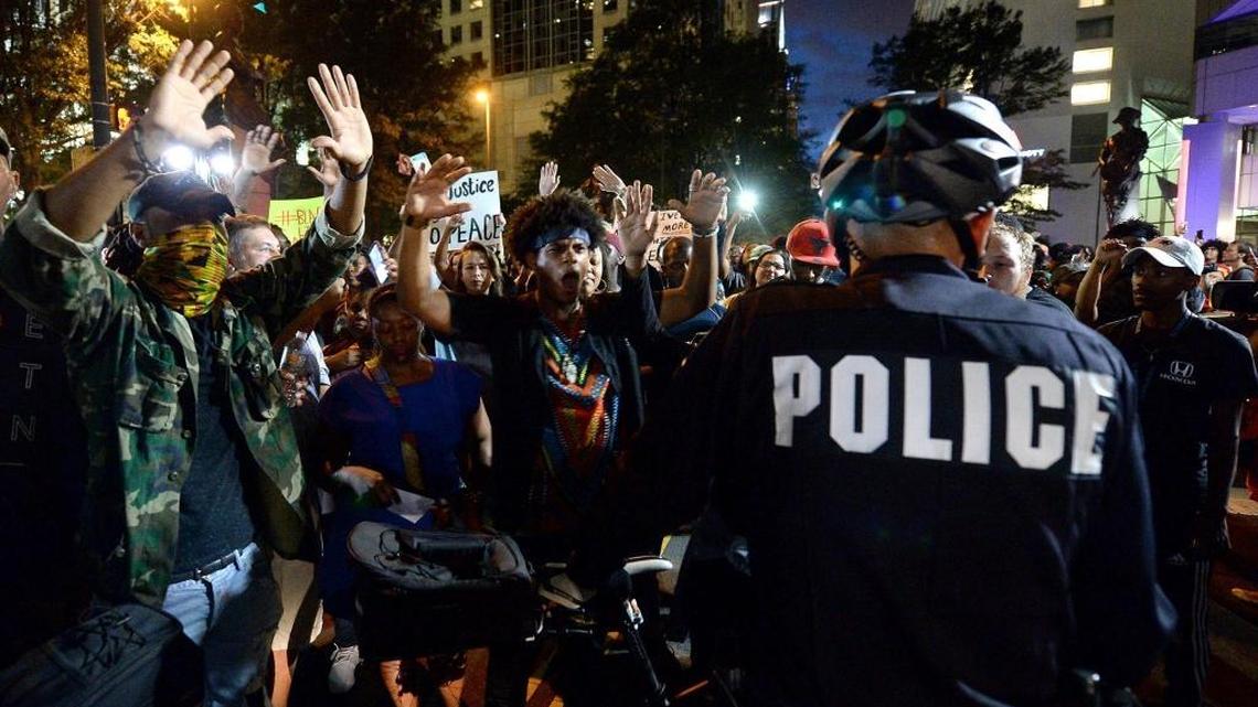 Protesters confront bicycle officers along Trade Street in Charlotte on Wednesday night.