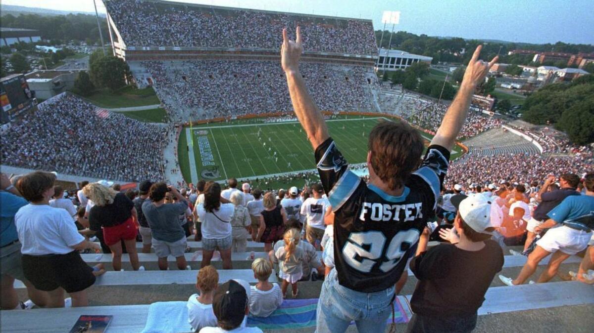 Carolina Panther fans celebrate at the opening home preseason game kick-off in Clemson, Aug.12, 1995.