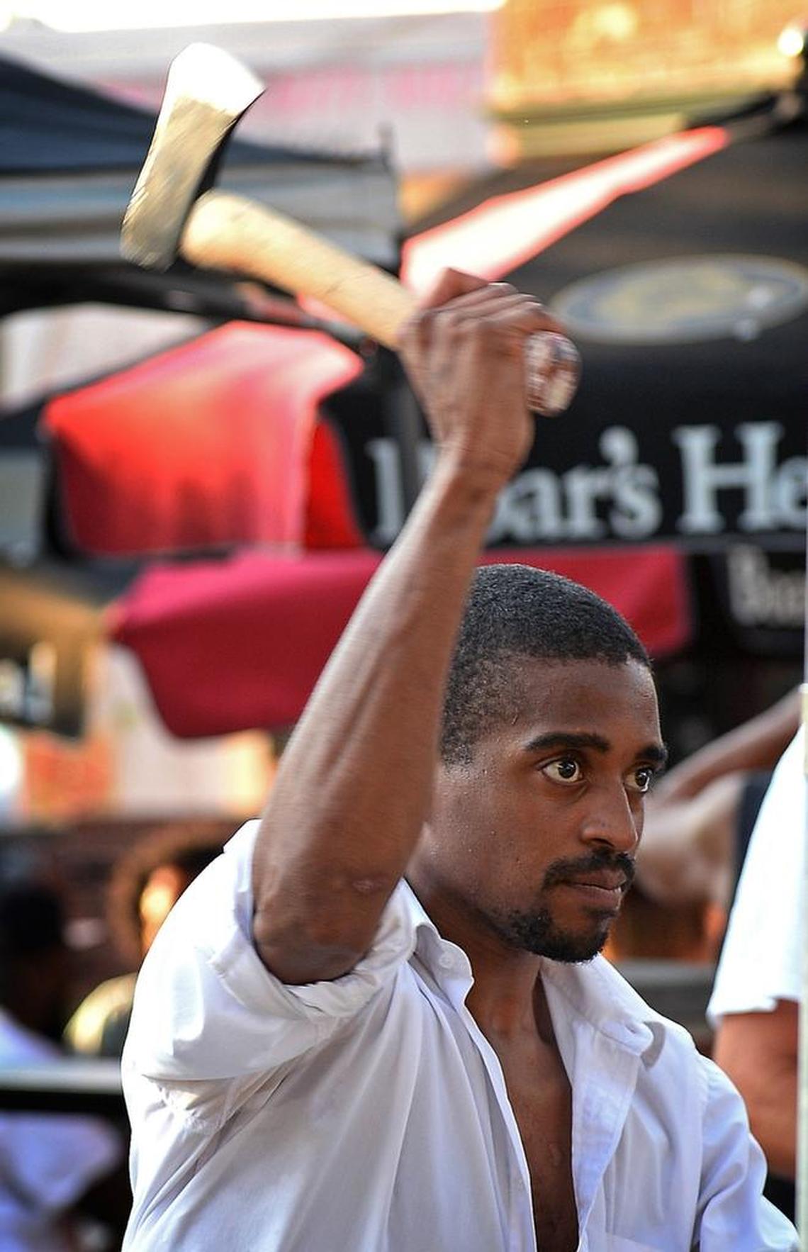 Devin Pointe follows through on his axe throw.