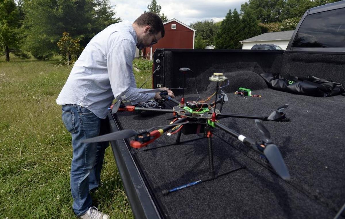 Greg Baker prepares to fly his custom built drone at his Charlotte home. He said drones can “spark the imagination” and attract kids to computer science and engineering.