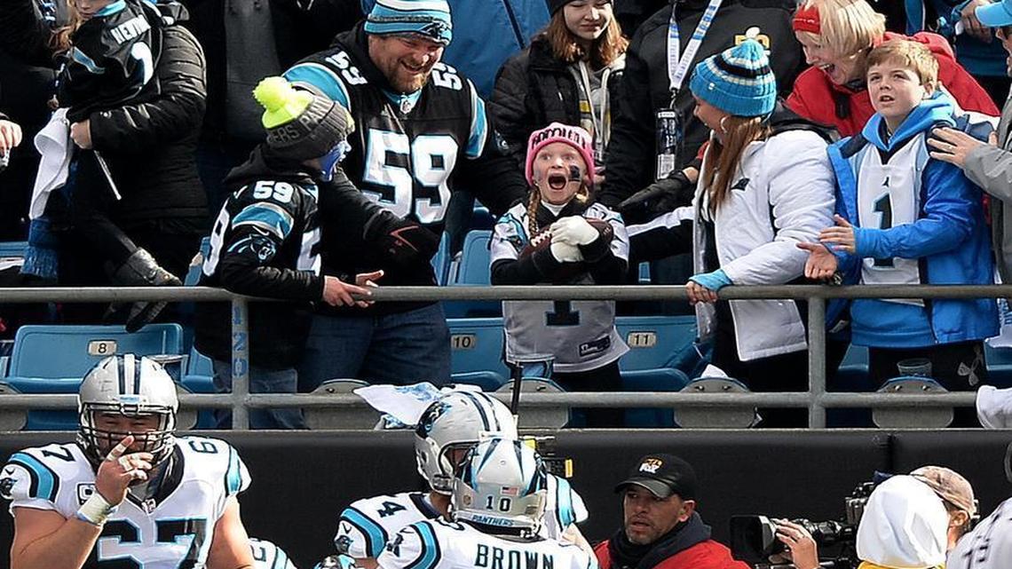 A stunned Isabella Bottomley, 8, reacts after Carolina Panthers running back Jonathan Stewart gave her the ball he’d carried into the end zone for the first touchdown against the Seattle Seahawks Sunday. 