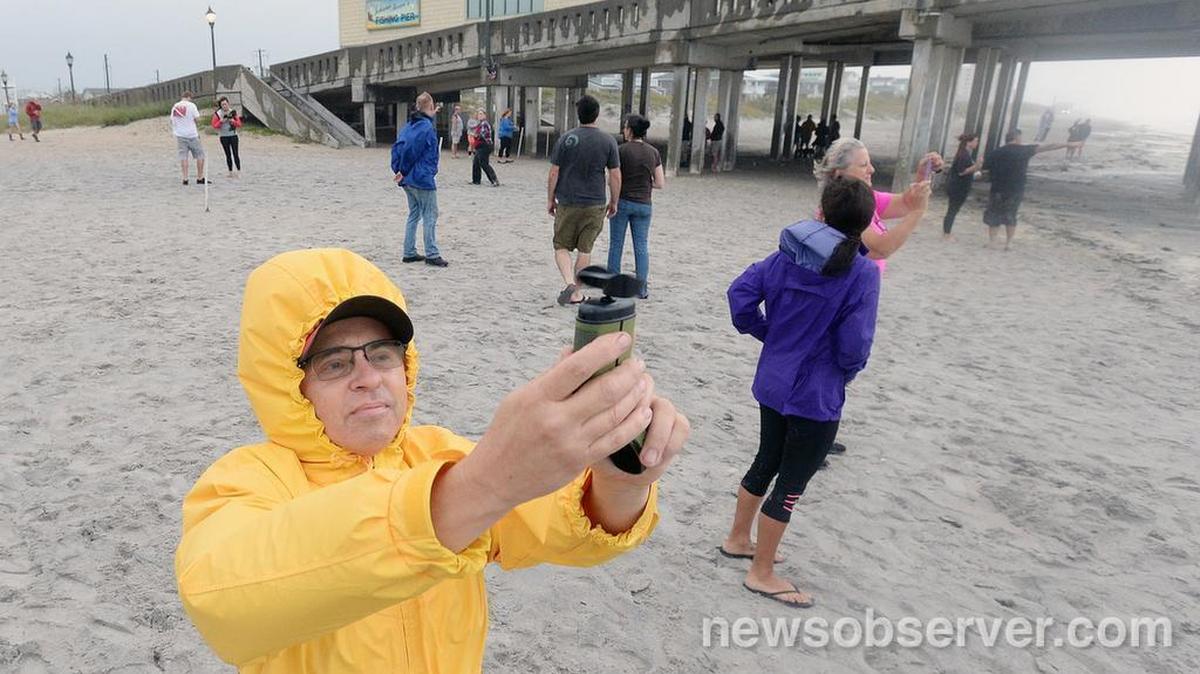 Jim Figliolia uses an anemometer to gauge the wind near the Johnnie Mercer Pier at Wrightsville Beach, N.C. Saturday, October 8, 2016. He recorded a gust of 45 mph as this photo was taken.