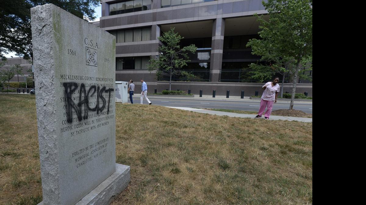 
The word “racist” has been painted on a Confederate monument that sits across from the Charlotte Mecklenburg Police Department outside the Old City Hall, Wednesday, July 15, 2015.
