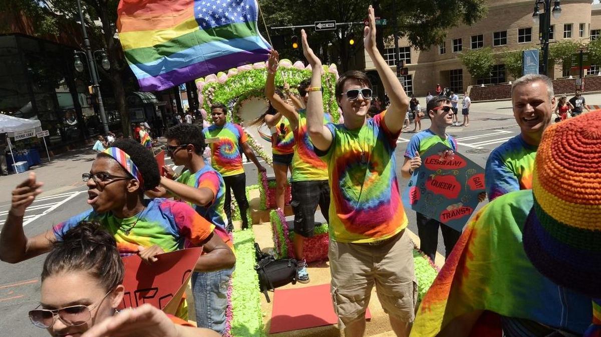 Time Out Youth members of Charlotte wave to the crowd from float during one of the city’s Charlotte Pride Parades