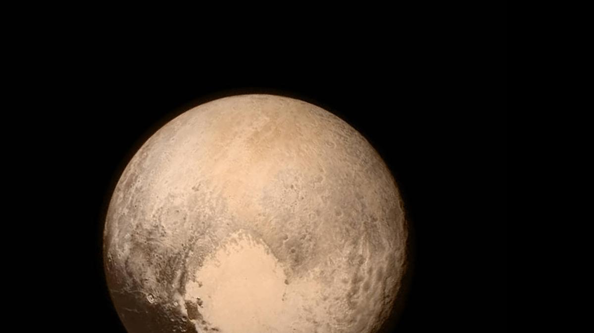 
Planetoid Pluto is pictured from NASA’s New Horizons as the spacecraft was 476,000 miles from the surface.  This view is dominated by the large, bright feature informally named the “heart,” which measures approximately 1,000 miles across. Even at this resolution, much of the heart’s interior appears remarkably featureless, possibly a sign of ongoing geologic processes, mission specialists say.
