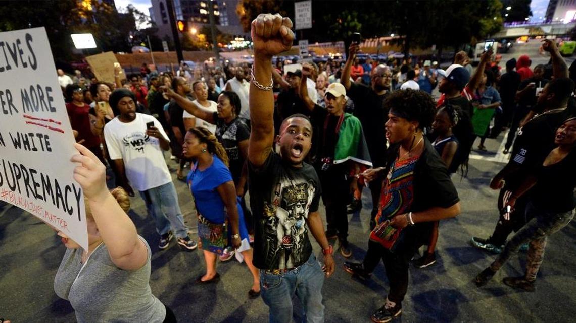 Protestors block an intersection near the Transit Center as they march uptown in Charlotte, NC on Wednesday, September 21, 2016. The protestors were marching and rallying against CMPD officer Brentley Vinson's fatal shooting of Keith Lamont Scott on Tuesday evening at The Village at College Downs apartment complex in the University City area.