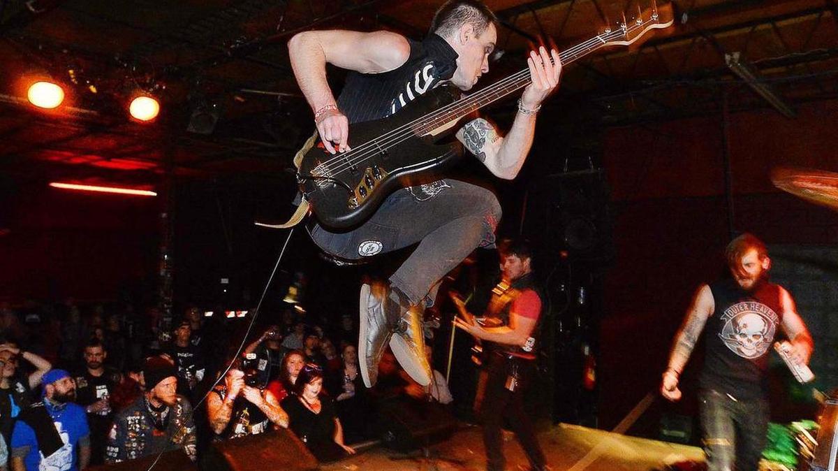 Christopher Wood 25 of Charlotte, bass player with the agressive punk band 'The Body Bags' leaps into the air during a performance at Tremont Music Hall on Dec. 19,2015, “the Tremont was a home for underground bands of Charlotte,I’ve been playing here since I was 16 and it has been phenomenal playing here” Wood said.