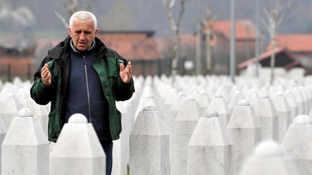 Sadik Selimovic, a survivor of July 1995 massacre in Srebrenica, prays by his relatives' grave at a memorial center in Potocari, in March. In June, students from five Mecklenburg high schools will travel to Bosnia-Herzegovina as part of the Charlotte-based Echo Foundation’s annual “Voices Against Indifference” program.