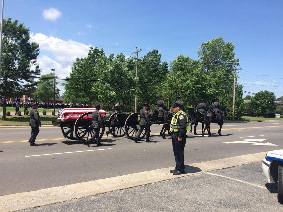 A horse-drawn caisson and honor guard lead a funeral procession for Sgt. Meggan Callahan, who authorities say was killed by an inmate at Bertie Correctional Institution in April.