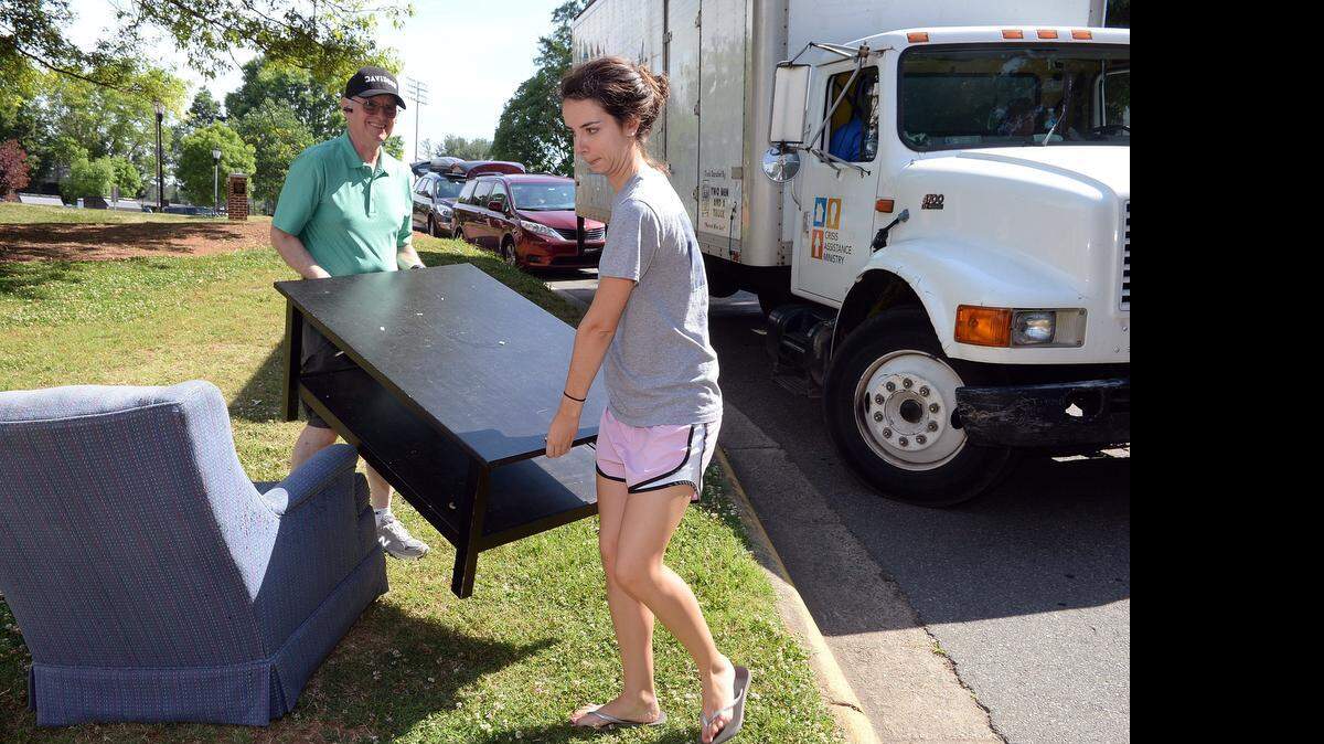 
Art Stephan from Long Island, NY, helps his daughter, Katie Stephan carry a table to the Goodwill truck, on Monday, May 18, 2015. For the last nine years, "Ditch and Dash" has been an end of the school year feature for Davidson students and campus staff, said Director of Building Services, Barbara Benson. Davidson students with the help of family and friends get rid of some of their dorm room items such as: sofas, mattresses,refrigerators, clothes, chairs or anything that they don't have room for, as they travel back home after graduation or just summer break. Non-profit agencies like Goodwill and Crisis Assistance Ministry come to the campus and collect items in fair to excellent condition to be later sold in their stores.
