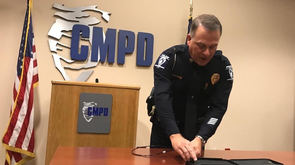 CMPD Capt. Brian Foley demonstrates a vehicle gun safe at police headquarters on Wednesday.