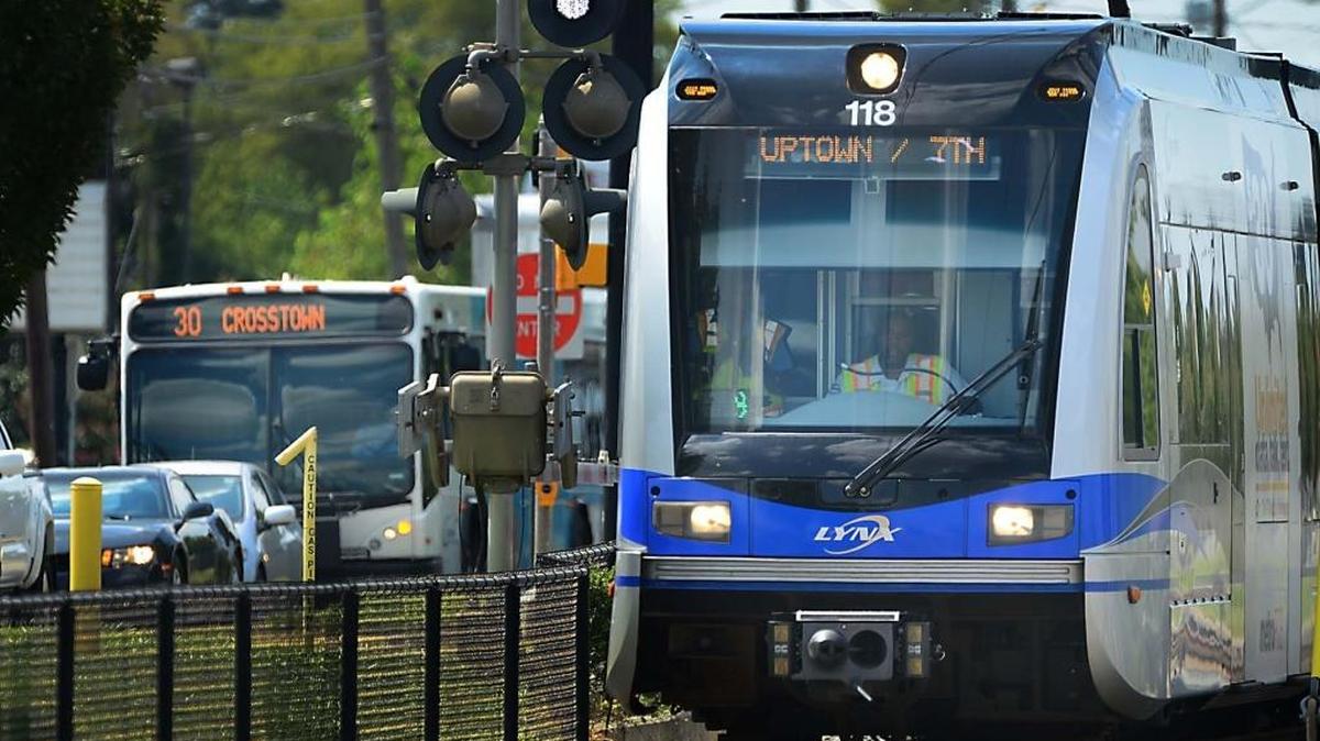 
A CATS transit bus and LYNX light-rail train travel along South Blvd. Tuesday, Sept. 1, 2015. 
