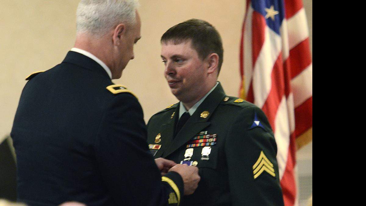 
Major General Jefforey Smith pins a Purple Heart medal on Sgt. Matt Cooke's uniform. Cooke, the Marine and Soldier from Stanly County wounded with 31 others during a shooting rampage at Fort Hood in Texas, got a purple heart medal at the VA Hospital in Salisbury on Saturday, April 25, 2015. 

