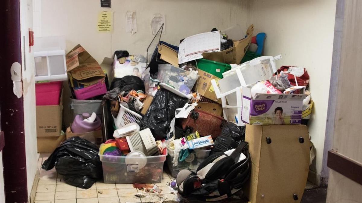 Piles of trash sit at the end of a hallway on the third floor of the Airport Parkway Inn & Suites.