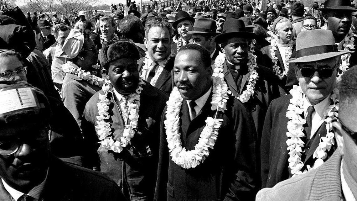 This March 21, 1965, file photo shows Martin Luther King Jr. and his civil rights marchers crossing the Edmund Pettus Bridge in Selma, Ala., heading for the capitol in Montgomery.