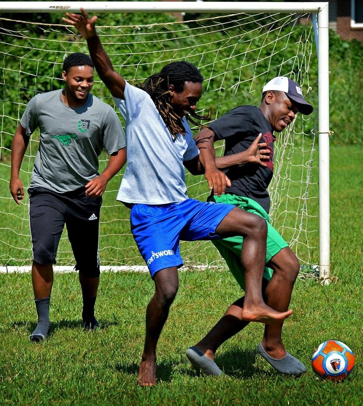 Jah'Qwel Williams, left, Deron Huggins, center and Tyree Watson, right, in Grier Heights.