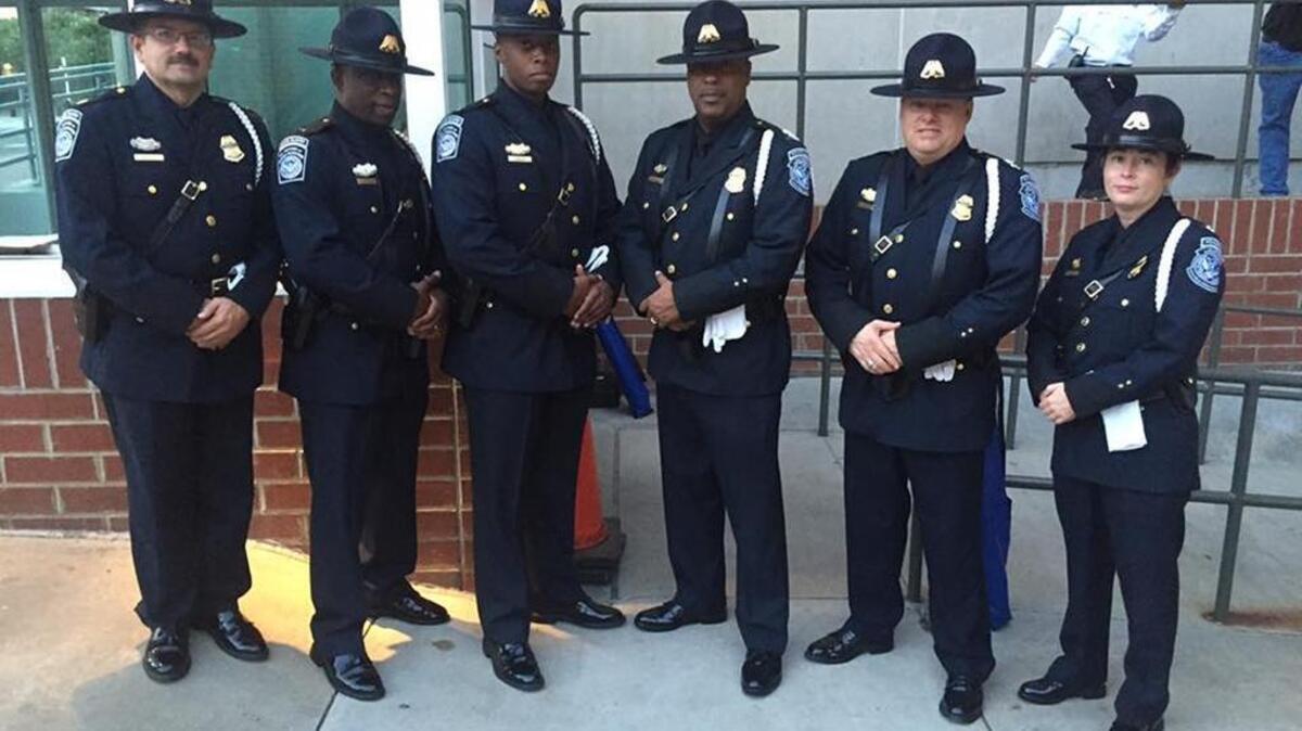 U.S. Customs and Border Protection agents, who refused to hand over their guns, waited outside the Spectrum Center for more than an hour Friday night. They were finally escorted inside, where they displayed the American flag during the national anthem at the start of the Professional Bull Riders show.