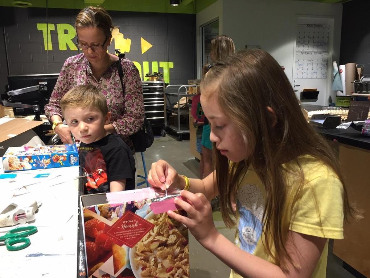 Carla Perezgrovas, 9 yrs., of Charlotte, NC works on building a pin hole projector with her mother, Anette and brother, Alex Perezgrovas on Monday, August 21, 2017 at Discovery Place in Charlotte, NC. The Perezgrovas' were preparing to watch the eclipse.
