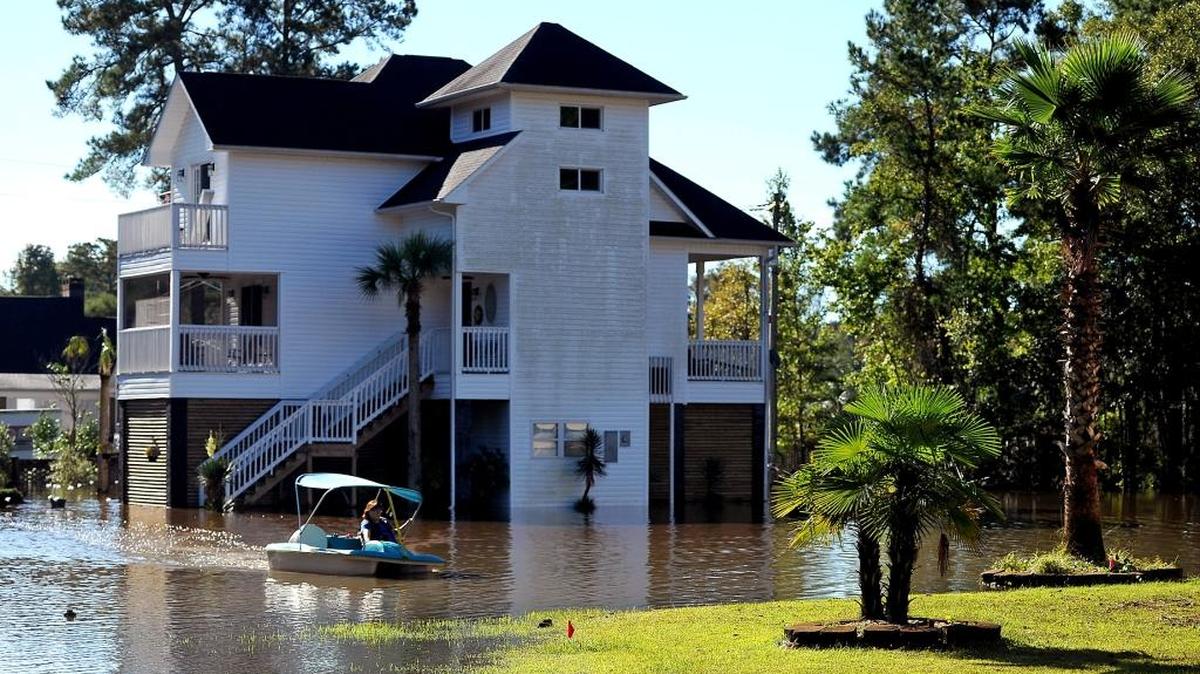 
Denise Bass uses a paddle boat to travel from her beach home to dry land on Wednesday. Bass lives off Forestbrook Road in Socastee, SC. She and her husband have been stuck at the home since Friday, only leaving to go to the grocery store.
