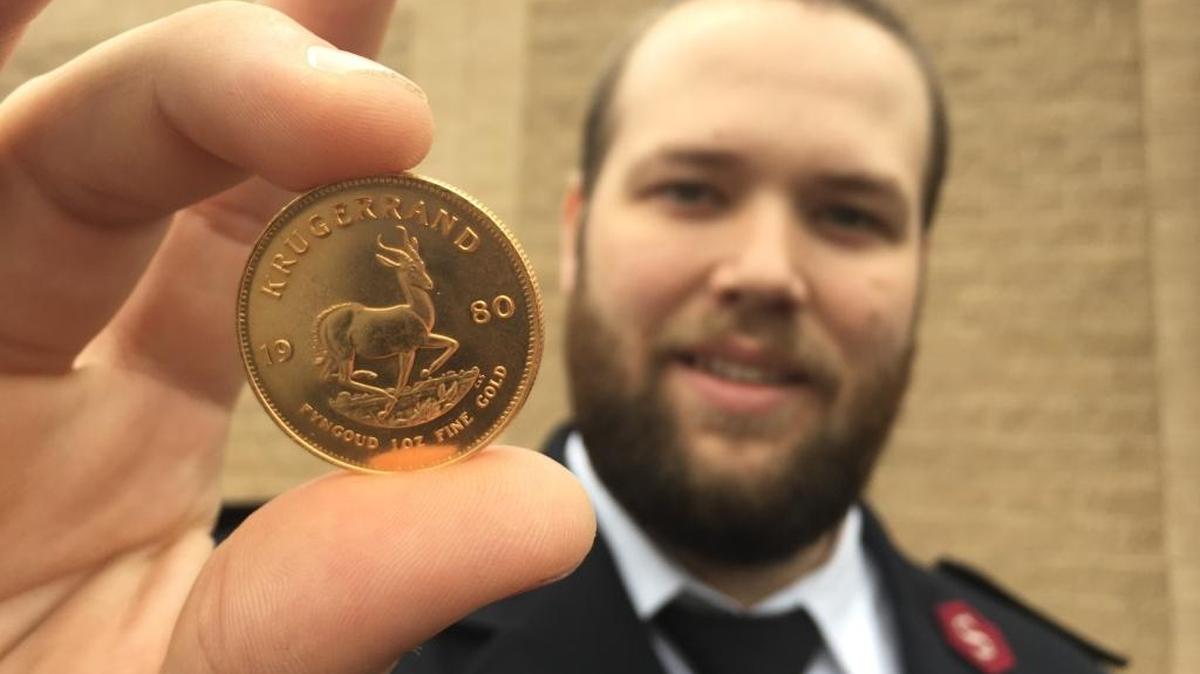 Lt. Mike McGee holds a one-ounce gold coin that was dropped into a Salvation Army Red Kettle on Dec. 4. A note wrapped around the coin request that the Salvation Army “use this anonymous gift to publicize giving.” The coin is valued at $1,201, according to an appraisal at a Brownlee Jeweler’s store in Rock Hill.