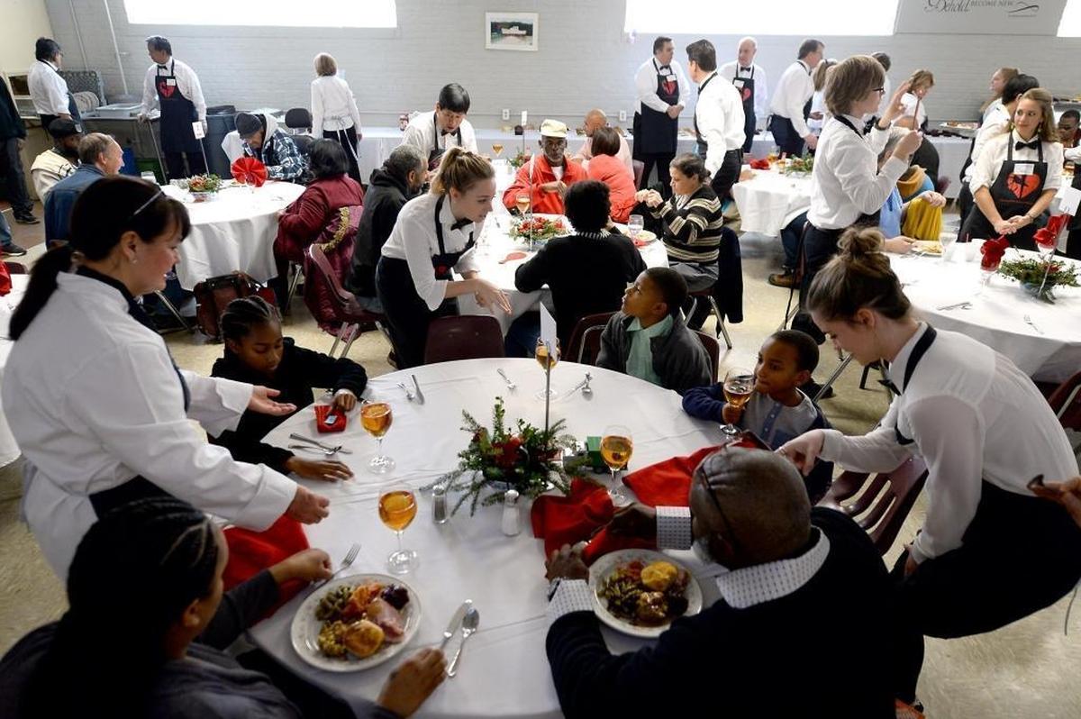 Volunteer servers take the orders of people at the Charlotte Rescue Mission. The mission offered attendees turkey, ham, sweet potatoes, dressing, green beans, cranberry sauce and a wide selection of desserts.