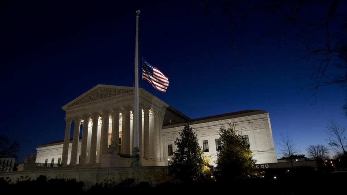 An American flag flies at half-staff in front of the U.S. Supreme Court building in honor of Supreme Court Justice Antonin Scalia as the sun rises in Washington, Sunday, Feb. 14, 2016. Scalia, the influential conservative and most provocative member of the Supreme Court, has died. He was 79.