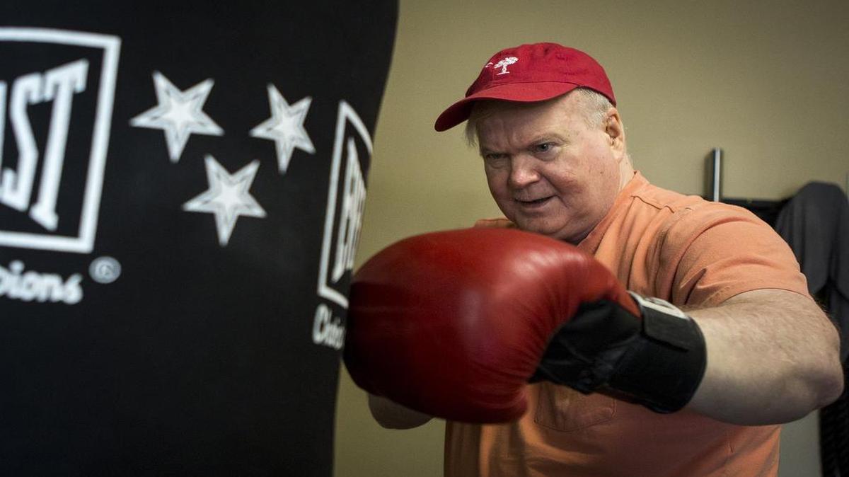 FILE PHOTO: Pat Conroy works out at the fitness studio he opened as part of his makeover. In three years, he lost 25 pounds, quit drinking, brought his blood pressure down and improved his diet.
