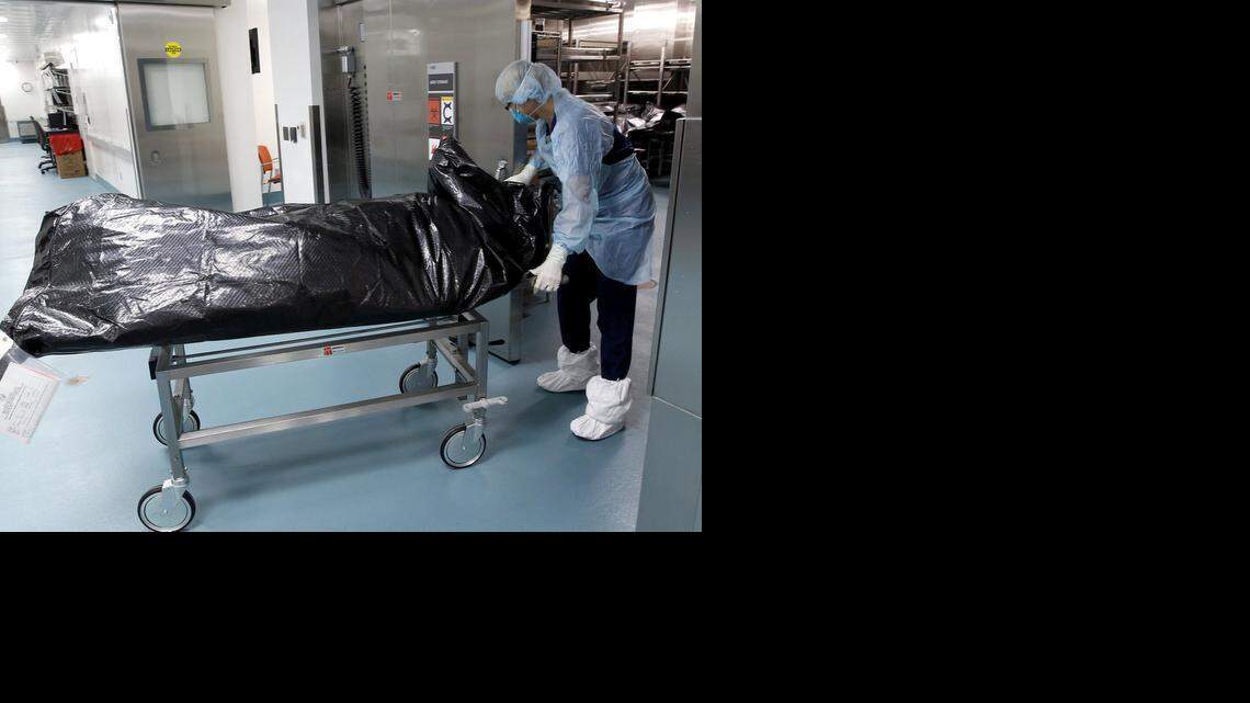 
Judith Page, an autopsy technician, wheels a body into the chilled body storage area after an autopsy was completed at the State Medical Examiner's Office last year. Kevin Gerity worked at the facility as an autopsy tech until resigning in a dispute with his supervisors. 
