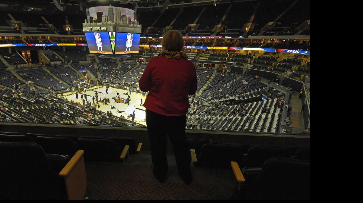
A woman watches the court from a suite before the start of an NBA game at Time Warner Cable Arena. The Charlotte City Council will vote Monday on a contract to spend nearly $900,000 on suite improvements to Time Warner Cable Arena, which is getting a nearly $30 million renovation.


