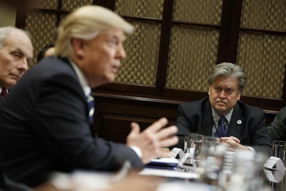 Former White House Chief Strategist Steve Bannon, at right, listens as President Donald Trump speaks during a meeting on cyber security in the Roosevelt Room of the White House in on Jan. 31.