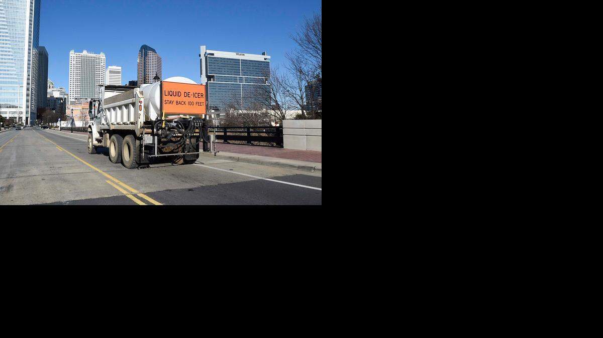 
A Charlotte Department of Transportation vehicle heads through uptown Charlotte on South Tryon street after spreading brine on the bridge over Interstate 277 on Sunday to prepare the roads for Monday's winter storm.
