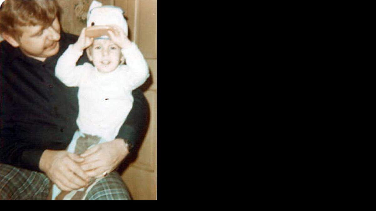
John Kees sits in the lap of his father, Marion Kees, in this 1970s photo. Marion Kees died in the Beirut bombing of the U.S. Marine Corps barracks in 1983. John is now 42 years old and living in Fort Mill, S.C. 
