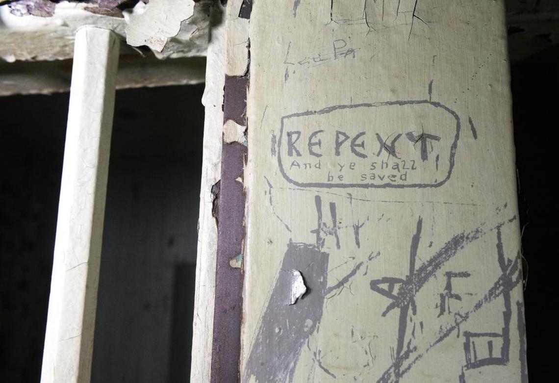 Graffiti visible on the outside wall of a jail cell at the long-defunct Mecklenburg jail, which closed in the 1960s. Most of the jail has remained untouched since then, so you can still see graffiti left by inmates 50 years ago.