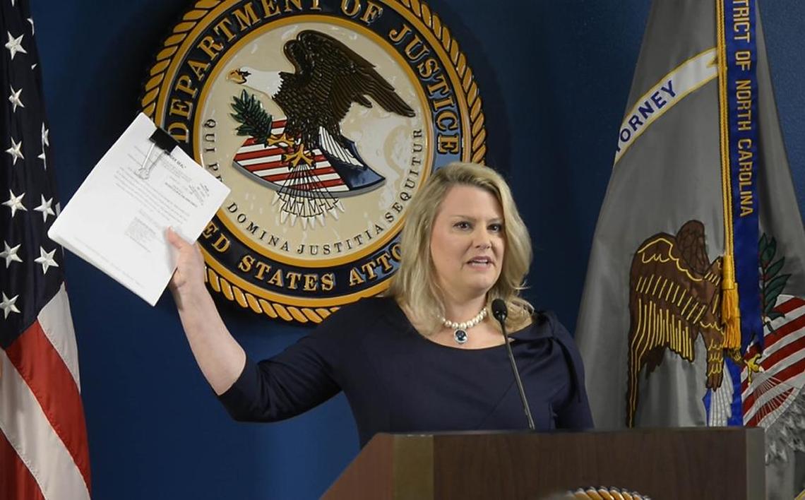 Jill Westmoreland Rose, U.S. Attorney for the Western District of North Carolina, holds up a copy of the indictment while speaking to the media about the federal charges against 83 alleged "United Blood Nation" gang members during a press conference on Thursday, May 18, 2017.