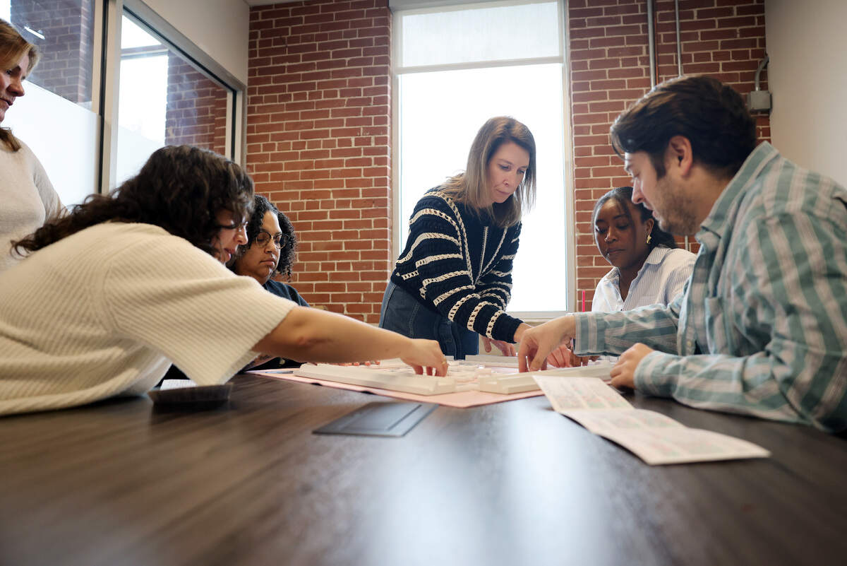 Mahjong instructor Lauren Ulrey teaches the game to Charlotte Observer newsroom staff. From left are Emily Broyles, Desiree Mathurin, Briah Lumpkins and Jeff Chamer.